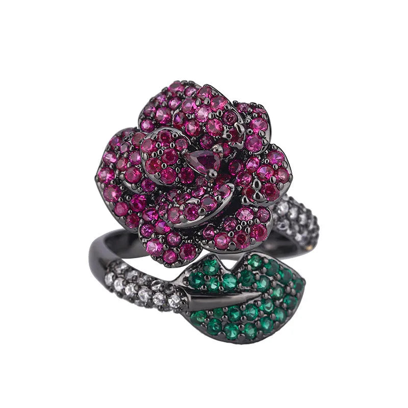 Gold-plated women's ring with a geometric black gold flower design and simulated red corundum detail.