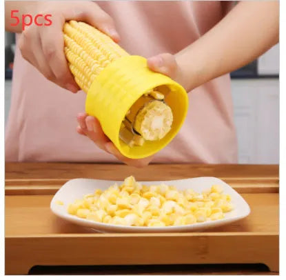 Yellow manual corn grinder thresher with corn-shaped PP handle and stainless steel shelling gear.
