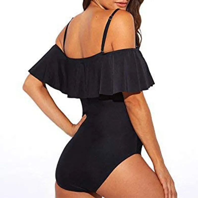 Black one-piece swimsuit with ruffled straps and side cut-out panels on a mannequin.