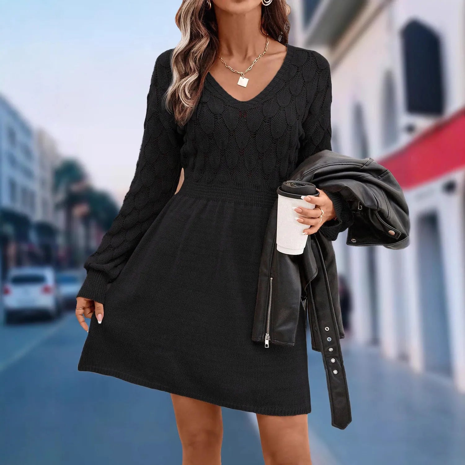Woman wearing an apricot coloured acrylic V-neck ethnic dress with 3D patterns and a high waist.