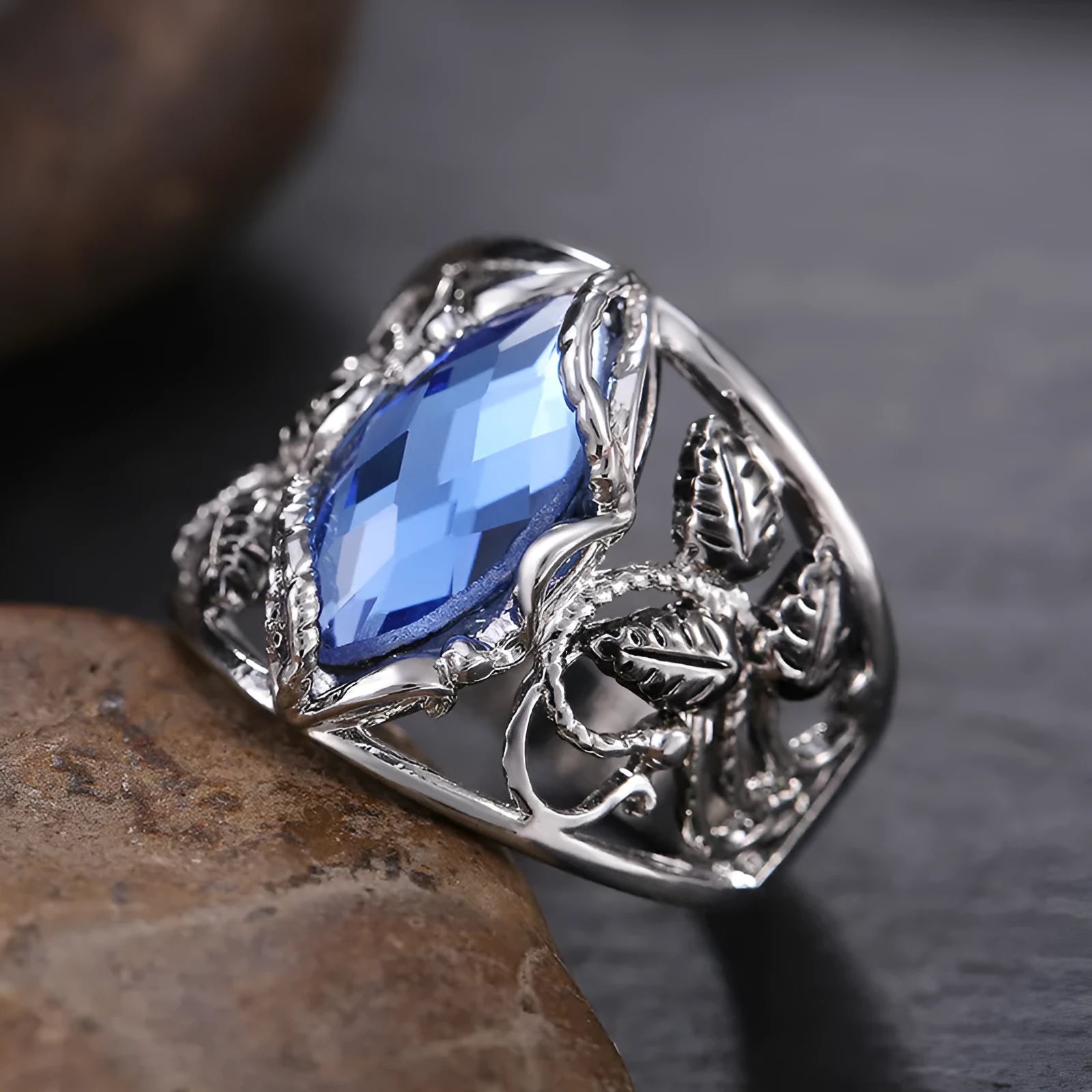 Blue horse eye shaped crystal ring for women on a hand, showing its geometric alloy design.