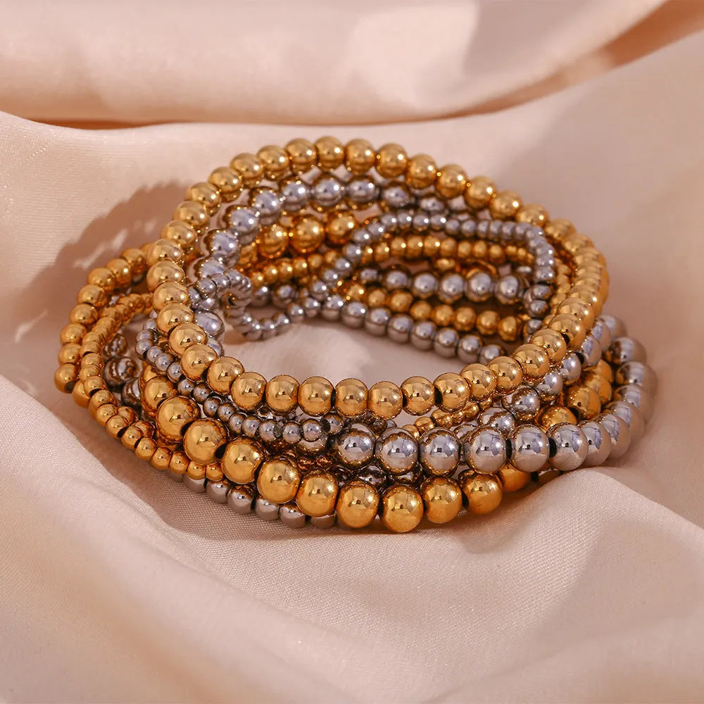 Stainless steel plated elastic bead bracelet with round geometric beads in gold finish