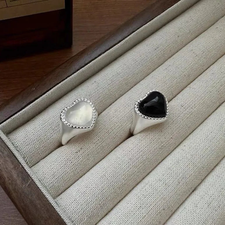 Adjustable open mouth sterling silver ring with a black heart-shaped agate stone.