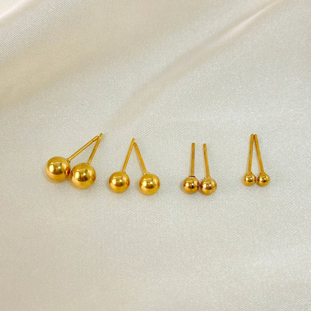 Stainless steel round ball stud earrings on a plain background, showing gold and silver tone options.