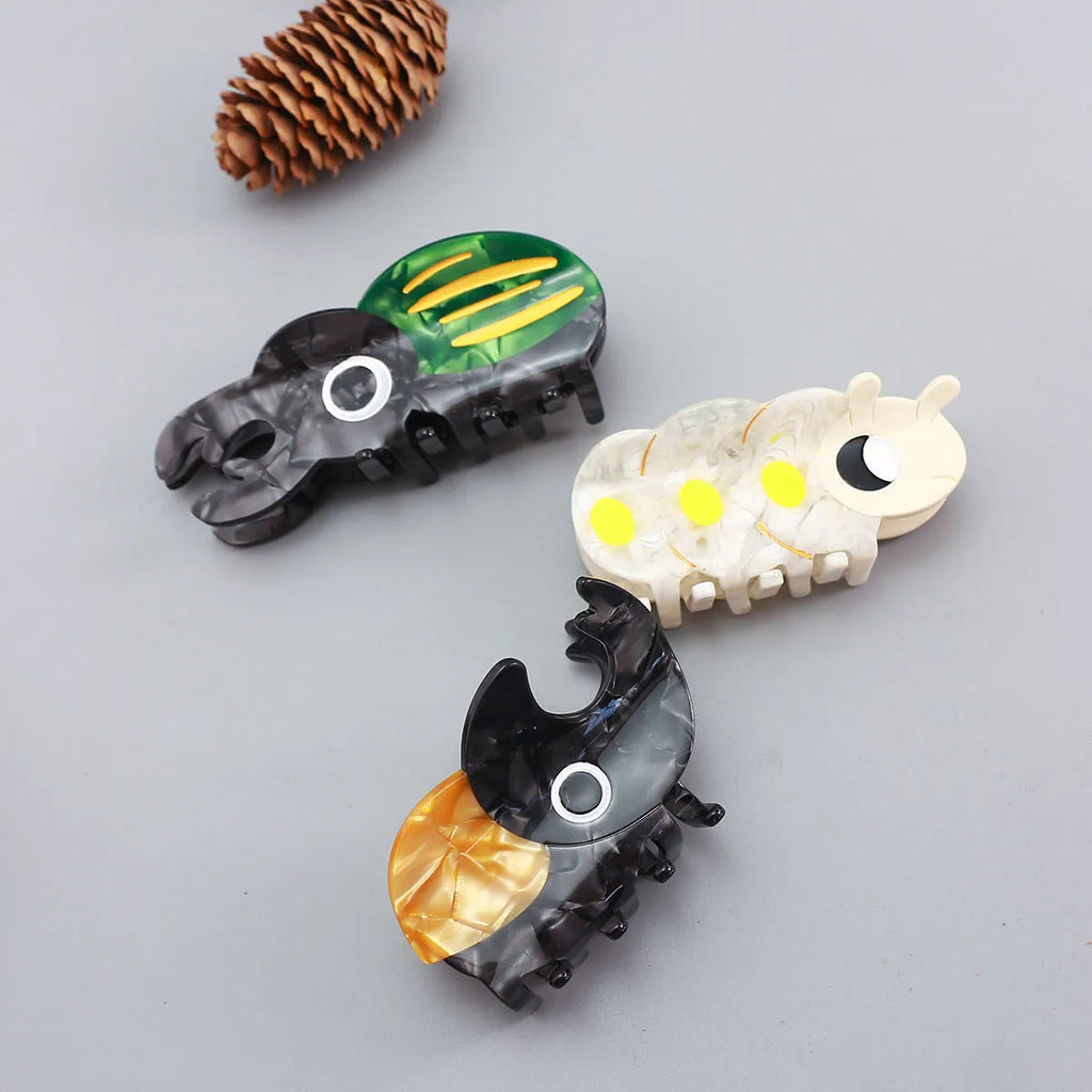 Handmade cartoon beetle and caterpillar design grip made from green cellulose acetate for stationery