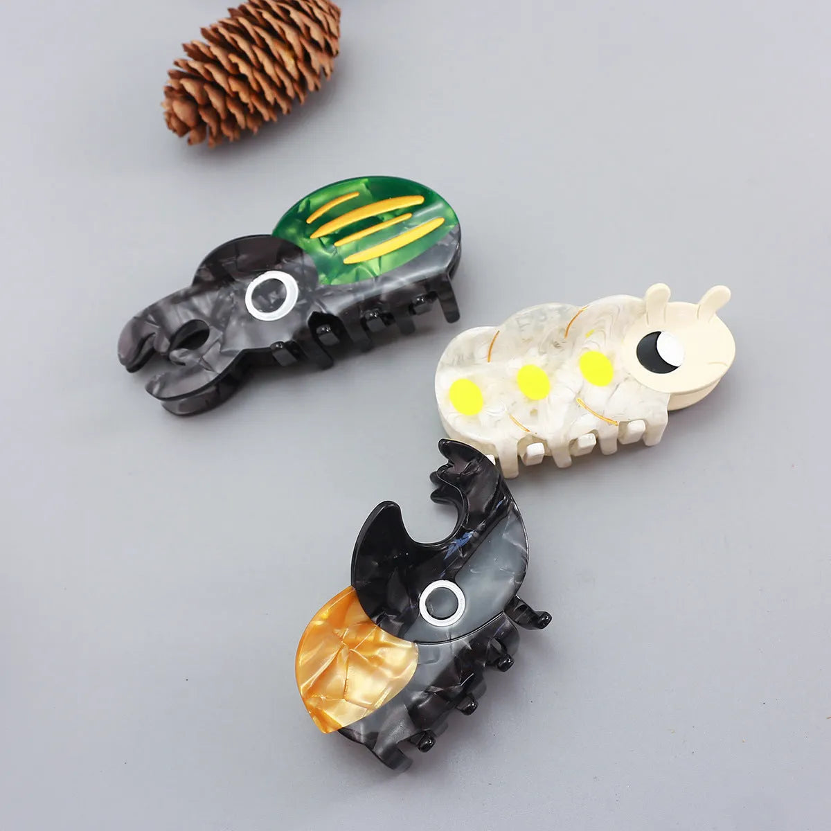 Handmade cartoon beetle and caterpillar design grip made from green cellulose acetate for stationery