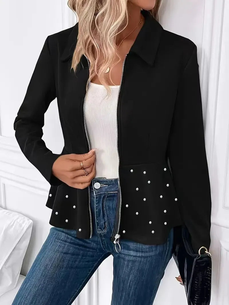 Women's black loose-fit coat with heavy-duty front zipper and ruffle hem detail.