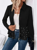 Women's black loose-fit coat with heavy-duty front zipper and ruffle hem detail.
