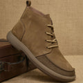 Grey genuine leather martin boots with wedge heel and lace-up front on a white background.