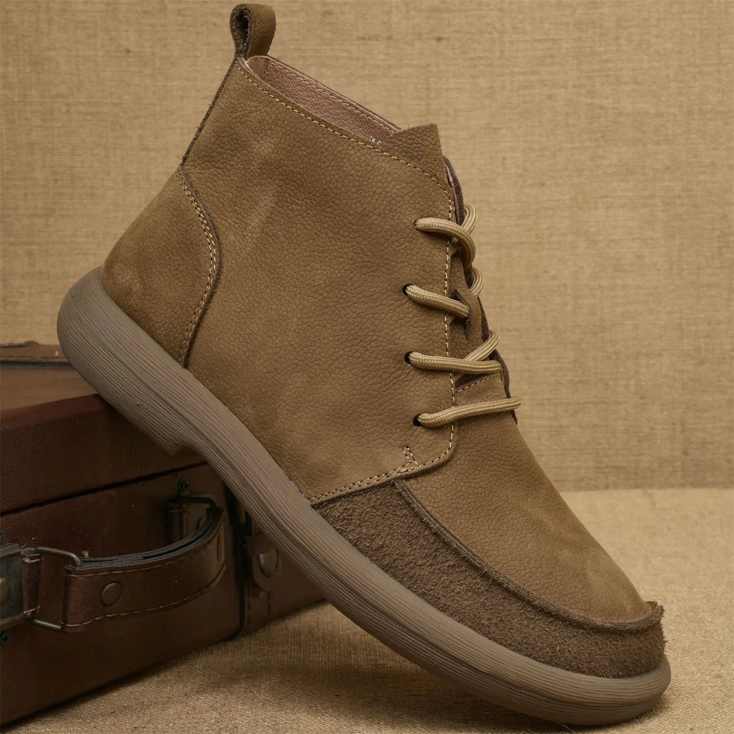 Grey genuine leather martin boots with wedge heel and lace-up front on a white background.