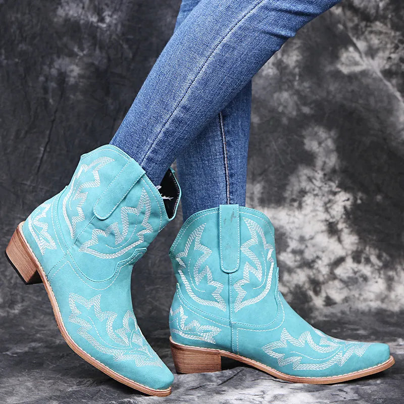 Blue women's cowboy boots with embroidery, a low wedge heel, and a pointed toe.