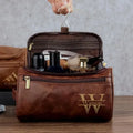 Men's black PU leather travel bag with seven interior compartments showing cosmetics section