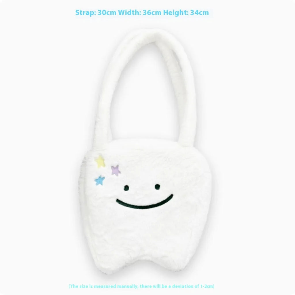 White plush tote bag with large cute teeth graphic, showing crossbody strap and zip opening.