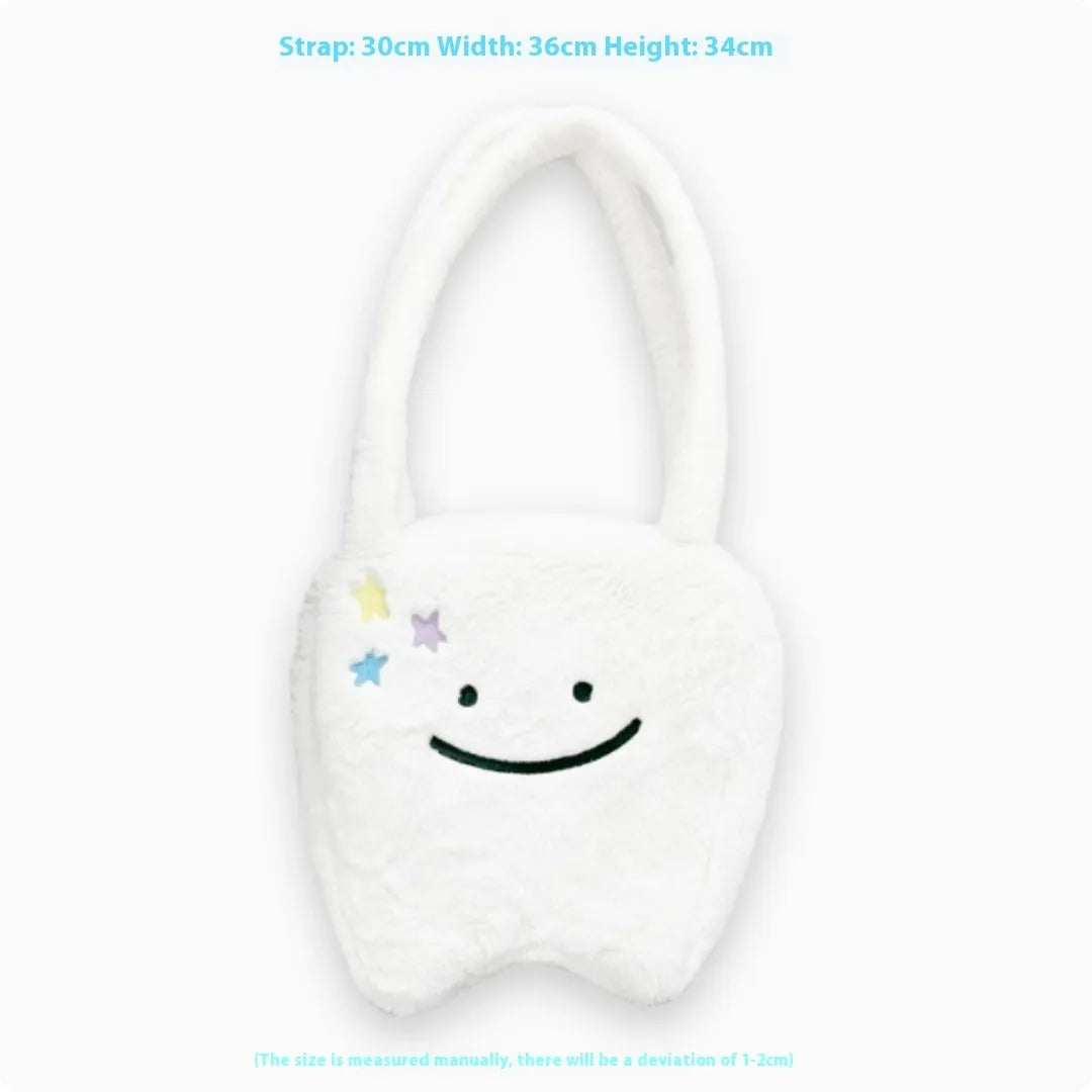White plush tote bag with large cute teeth graphic, showing crossbody strap and zip opening.