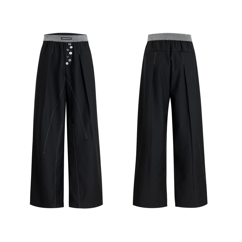 High-waisted drooping straight-leg trousers in black with button open line design detail.