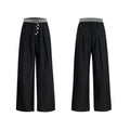 High-waisted drooping straight-leg trousers in black with button open line design detail.