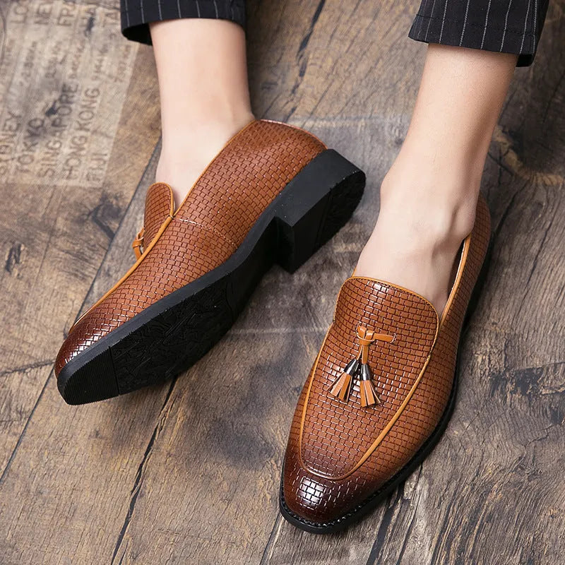 Men's black slip-on business shoes with pointed toe and tassel detail on artificial PU upper