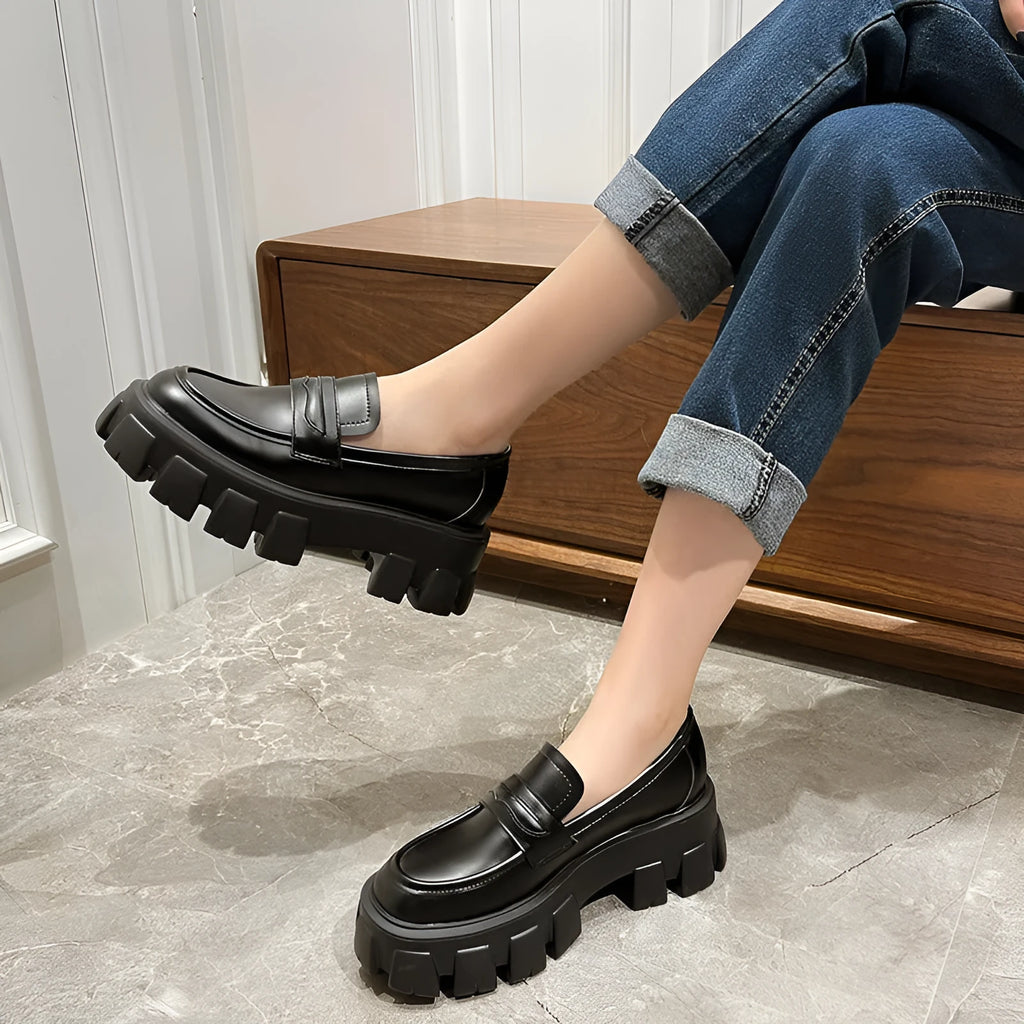 British style wide fat foot loafers in patent leather with a rubber sole.