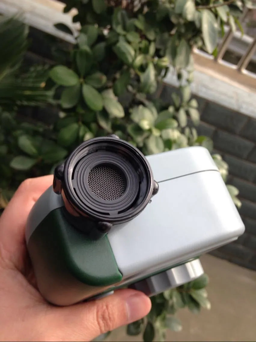 Green digital hose faucet timer with copper connector and dual outlets for garden irrigation