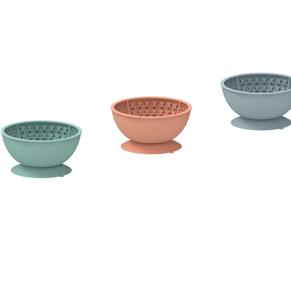 Cyan silicone dog licking mat slow feeder bowl with textured surface and suction cup base.
