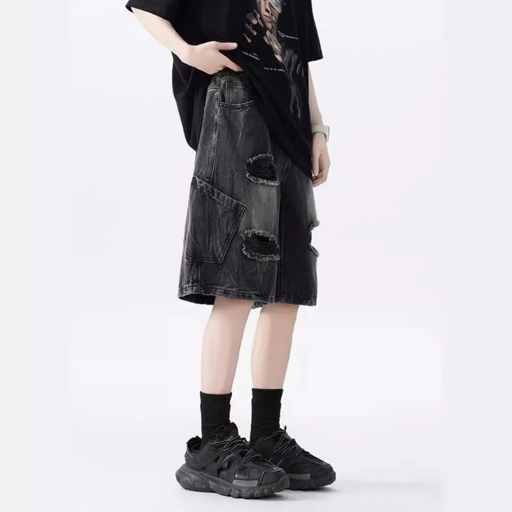 Women's distressed denim shorts with ripped detailing and washed vintage finish in loose retro fit