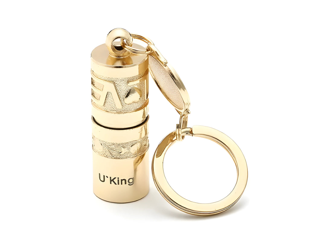 Gold zinc alloy waterproof LED keychain flashlight on a keyring.