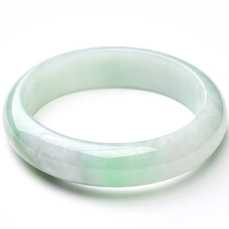 Light green jade bracelet on a white background, showing natural stone texture.
