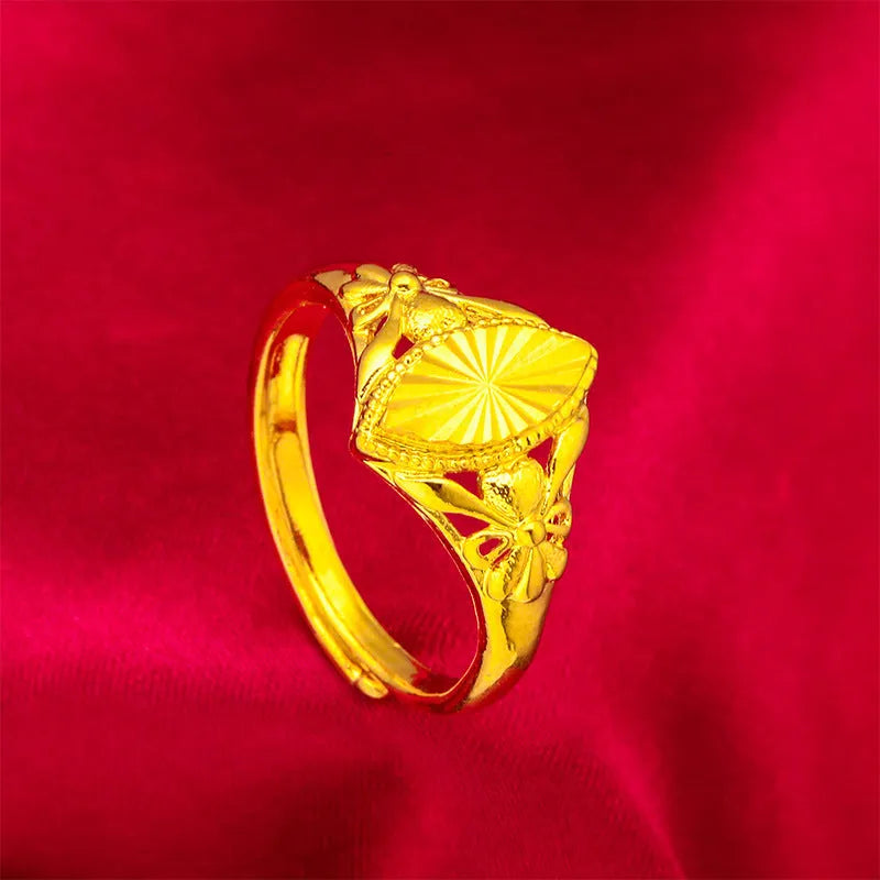 Gold coloured electroplated brass ring with a geometric open diamond flower design and textured details.