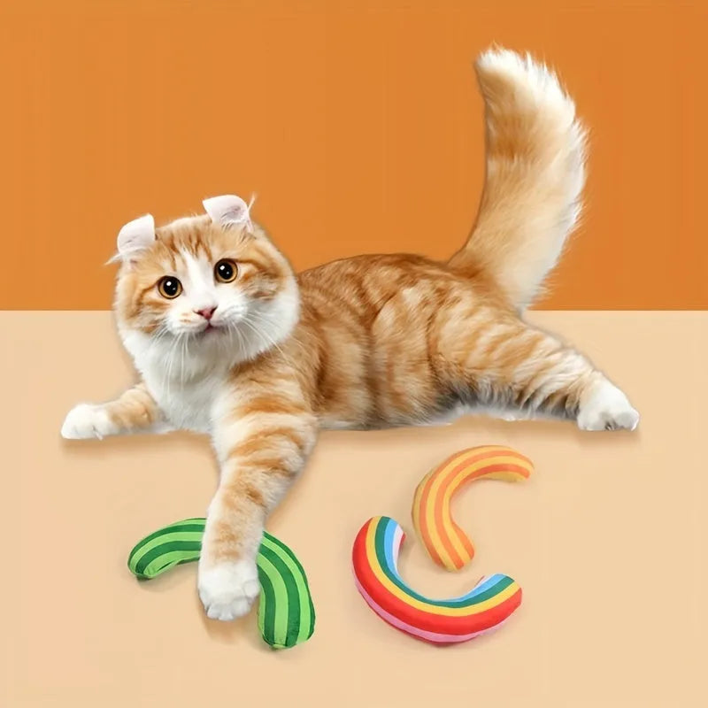 Set of four cat toys including a noise maker and a green striped catnip pillow on a neutral background.