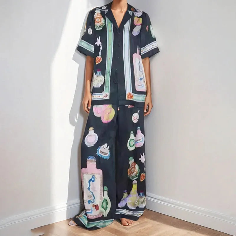 Black women's sleeve cardigan and trousers matching set with cartoon animation pattern.