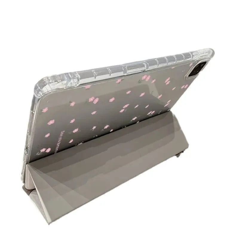 Transparent floral patterned tri-fold hard case for Apple iPad showing stand angle.