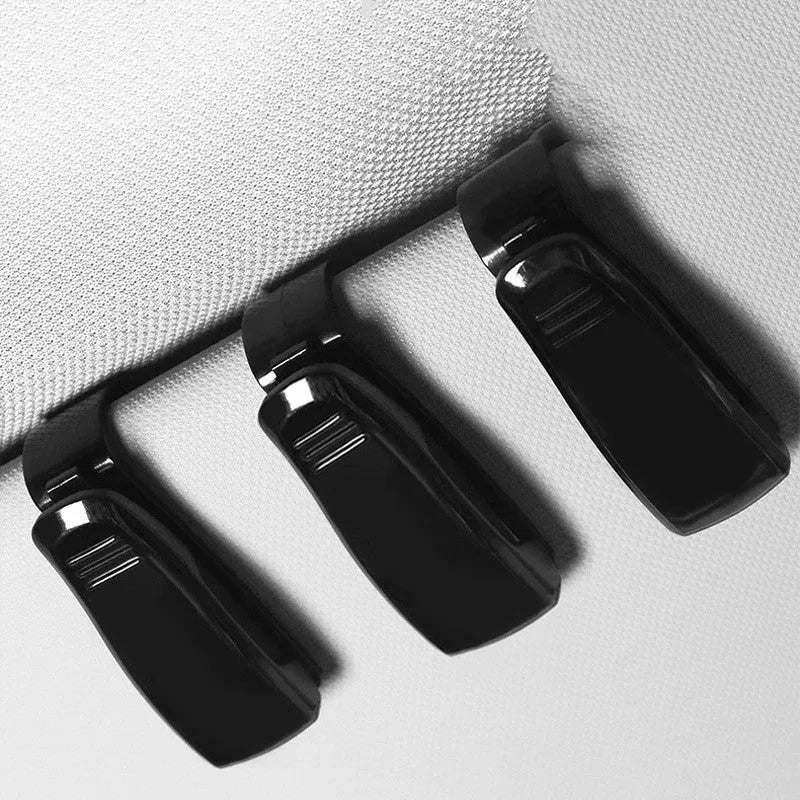 Black plastic car sunshade clip holder for glasses and tickets on a car visor