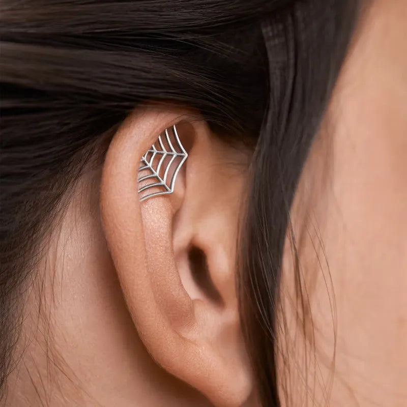 Gold and silver spider web stud earrings with geometric mesh pattern