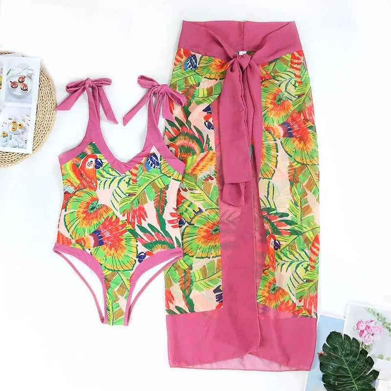 Pink floral print one-piece swimsuit with V-neck, covered belly design, and attached thin skirt