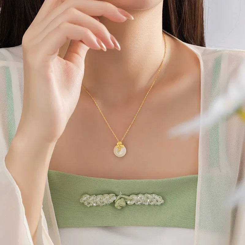 925 sterling silver ginkgo leaf pendant necklace, gold finish, with peace buckle and adjustable 41-50 cm chain on model clavicle
