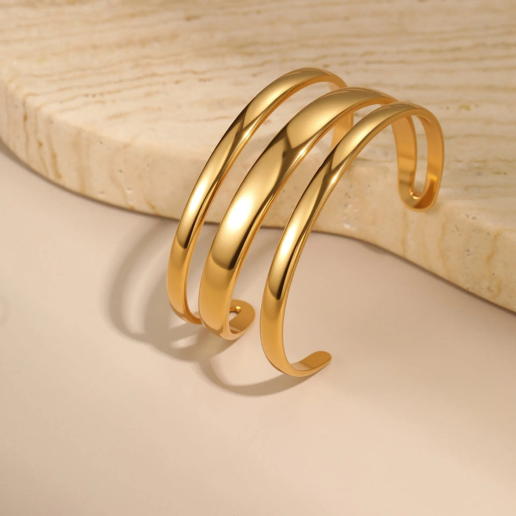 Women's stainless steel opening bracelet with geometric line design in gold or steel colour with 18K electroplated finish