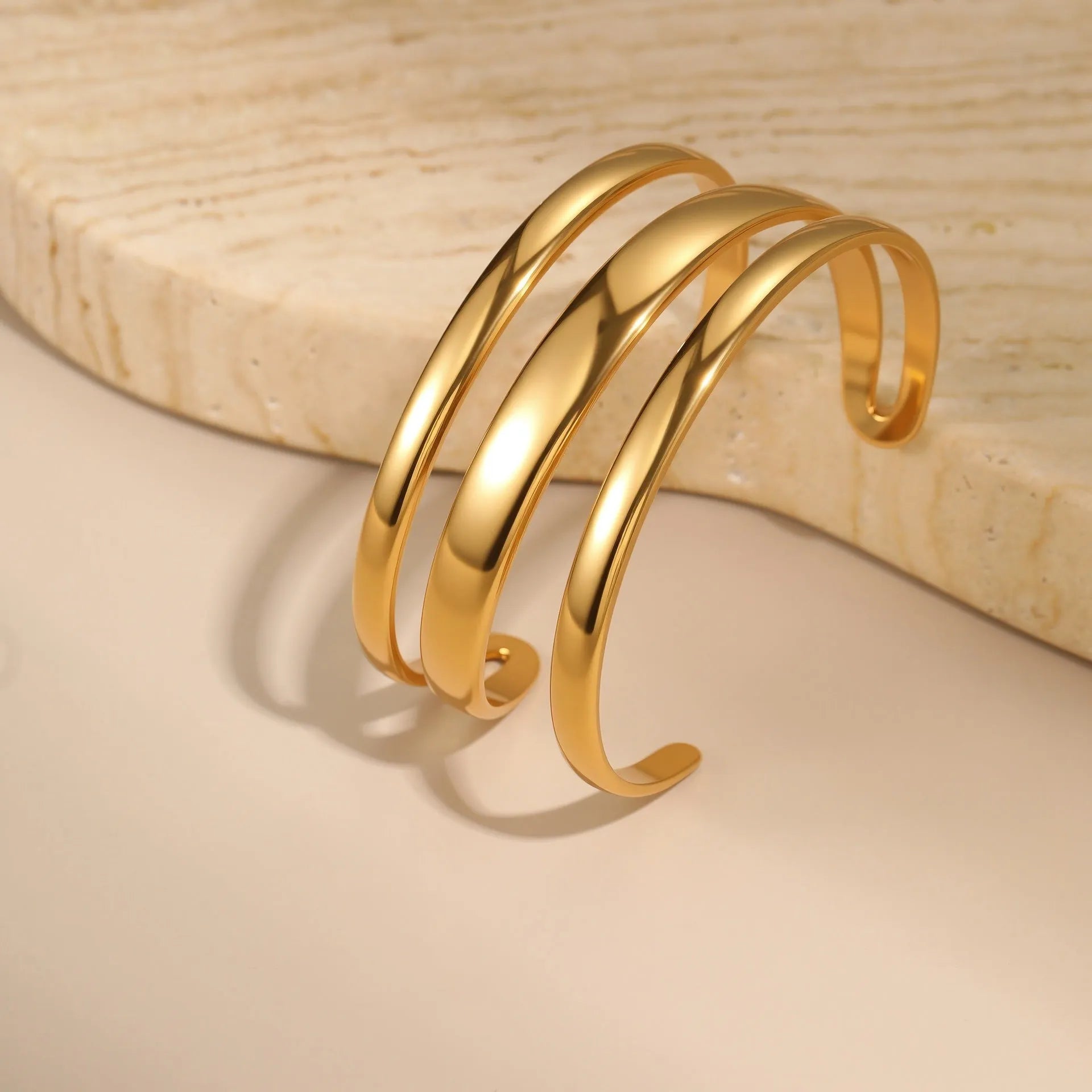 Women's stainless steel opening bracelet with geometric line design in gold or steel colour with 18K electroplated finish