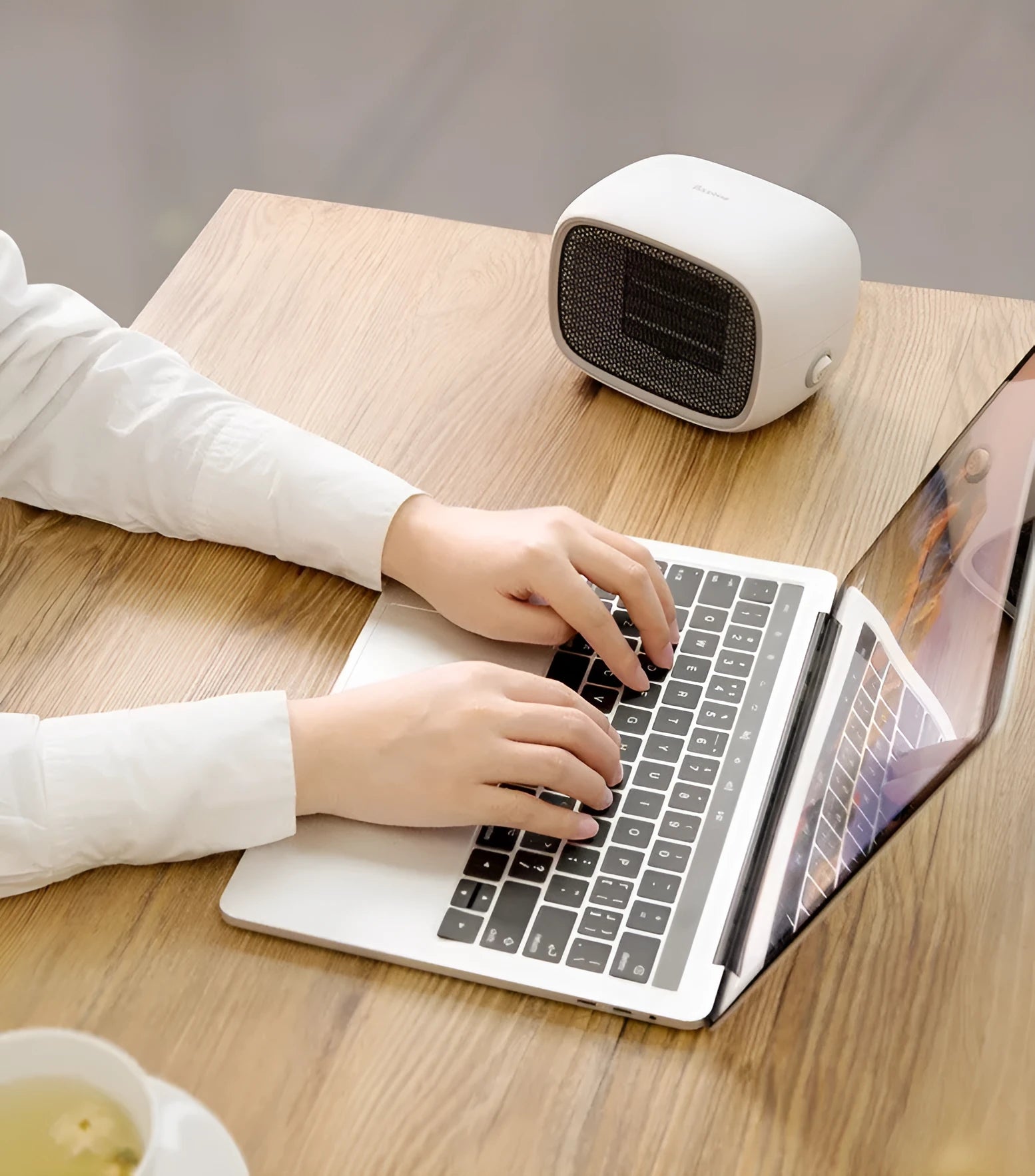Mini ceramic desk heater in green colour showing compact rectangular design with safety grille