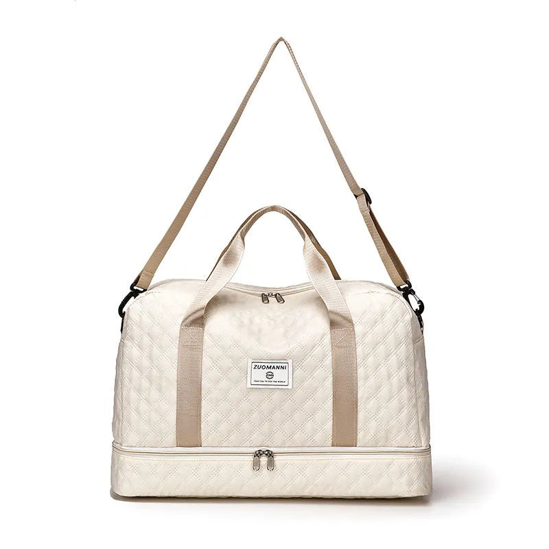 Large Oxford cloth travel bag in a solid colour with contrast stitching, shown with buggy and travel items.