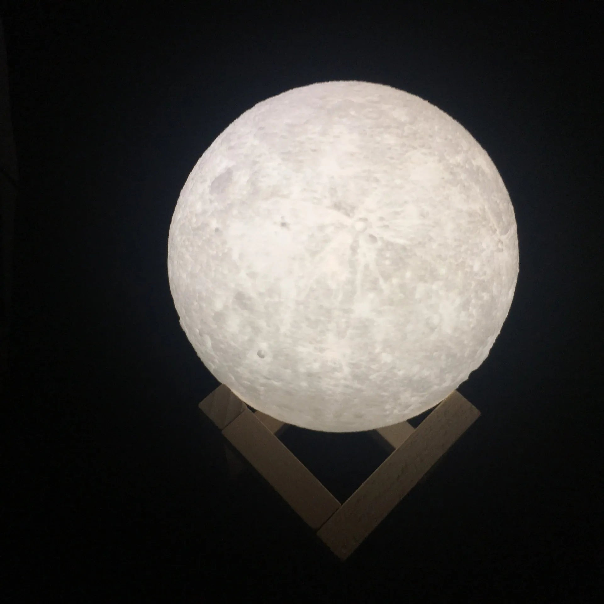 3D printed moon lamp on wooden stand with touch control ring at base, showing white and yellow light colours.