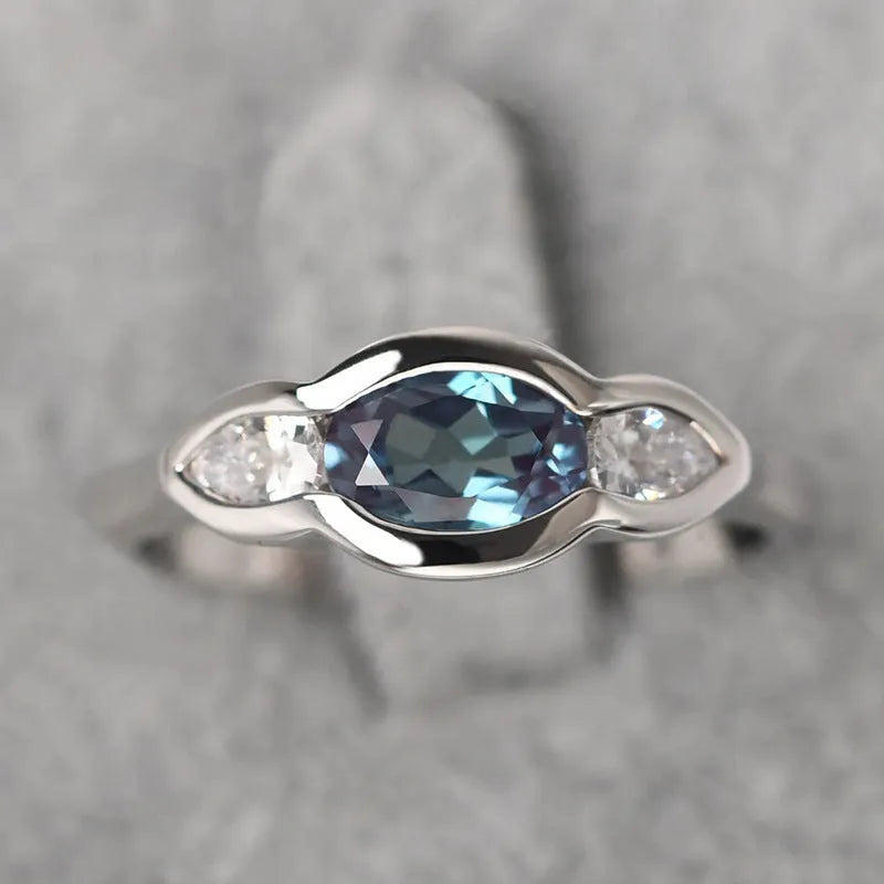 Women's geometric ellipse copper ring with inlaid zircon detail in white gold colour.