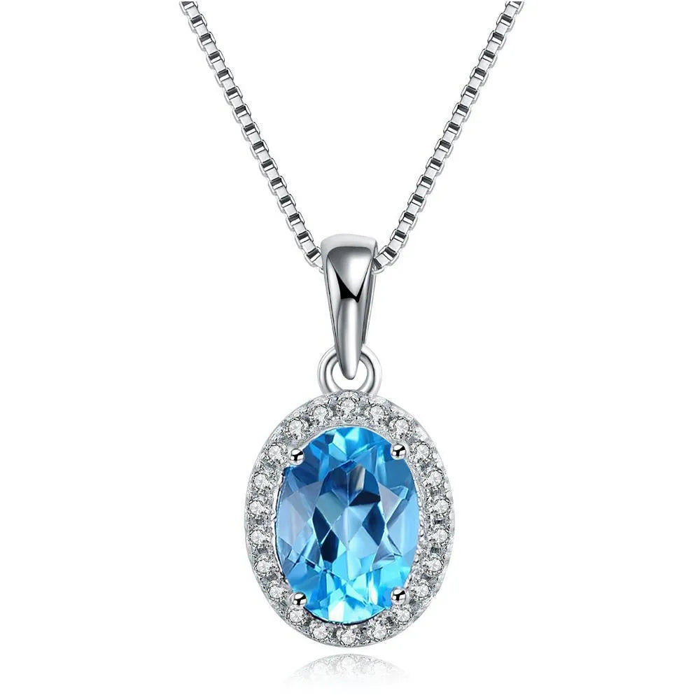 Women's 925 sterling silver and blue topaz four-piece jewellery set with geometric design, showing earrings, ring, necklace, and pendant.