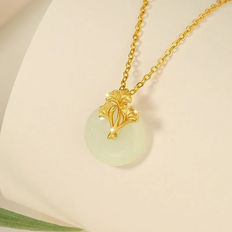 925 sterling silver ginkgo leaf pendant necklace, gold finish, with peace buckle and adjustable 41-50 cm chain on model clavicle