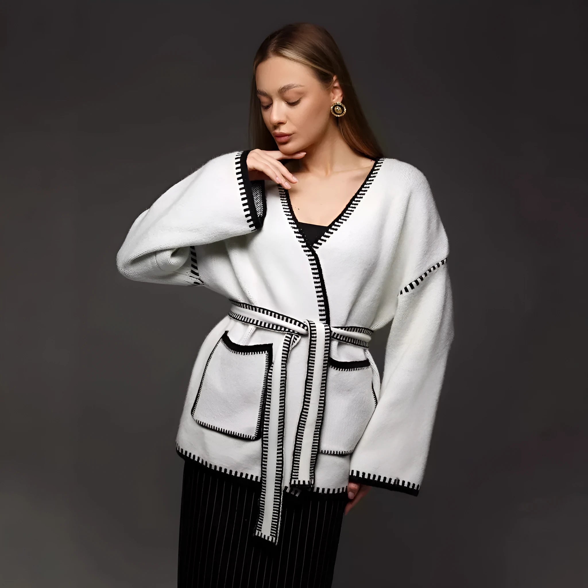 Loose fit knitted cardigan with lace-up sleeves in camel colour showing mid-length design