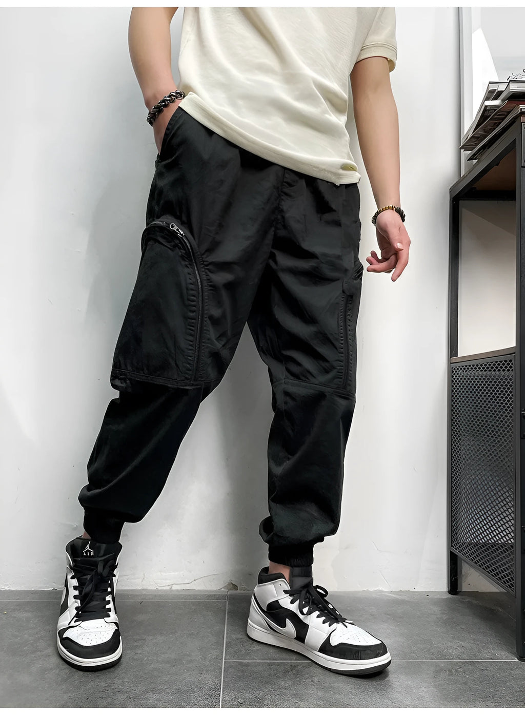 Men's elastic waist cotton cargo trousers with zippered pockets, loose fit, in khaki colour on plain background