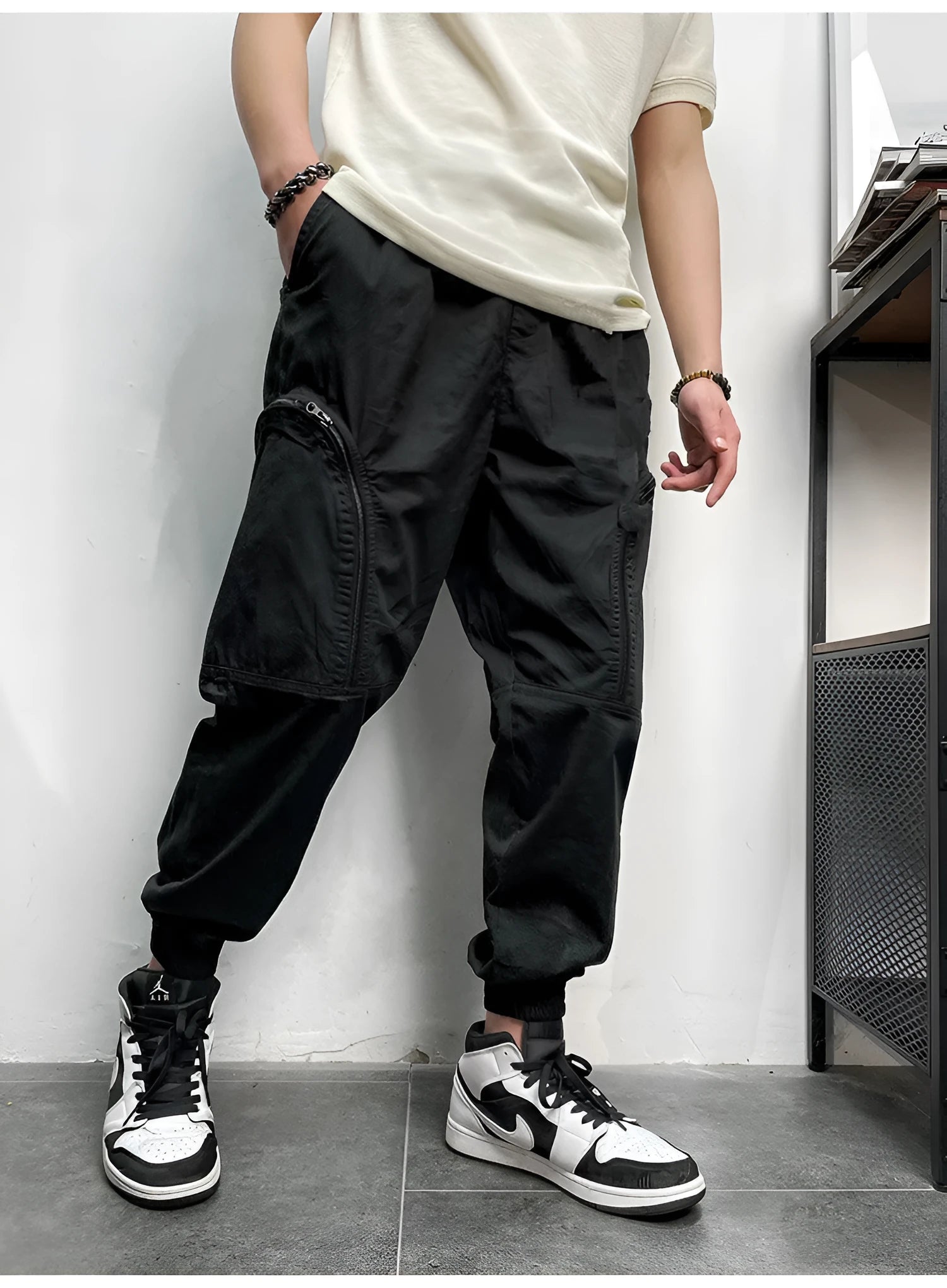 Men's elastic waist cotton cargo trousers with zippered pockets, loose fit, in khaki colour on plain background