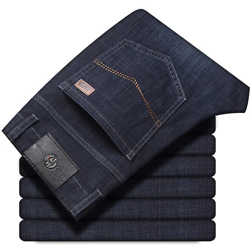 Men's black stretch denim jeans showing loose straight-leg fit with mid waist and zip fly detail