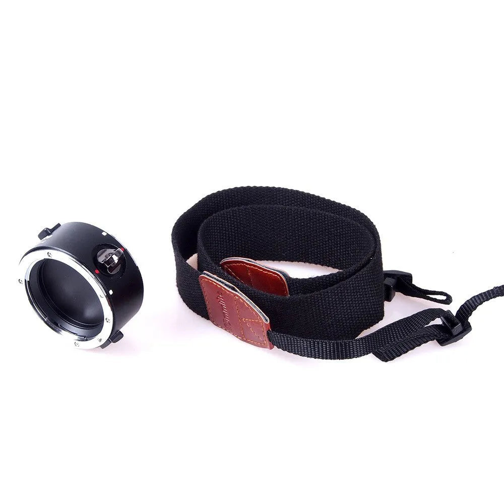Aluminium alloy camera lens flipper holder with stainless steel buckle on a cotton shoulder strap.