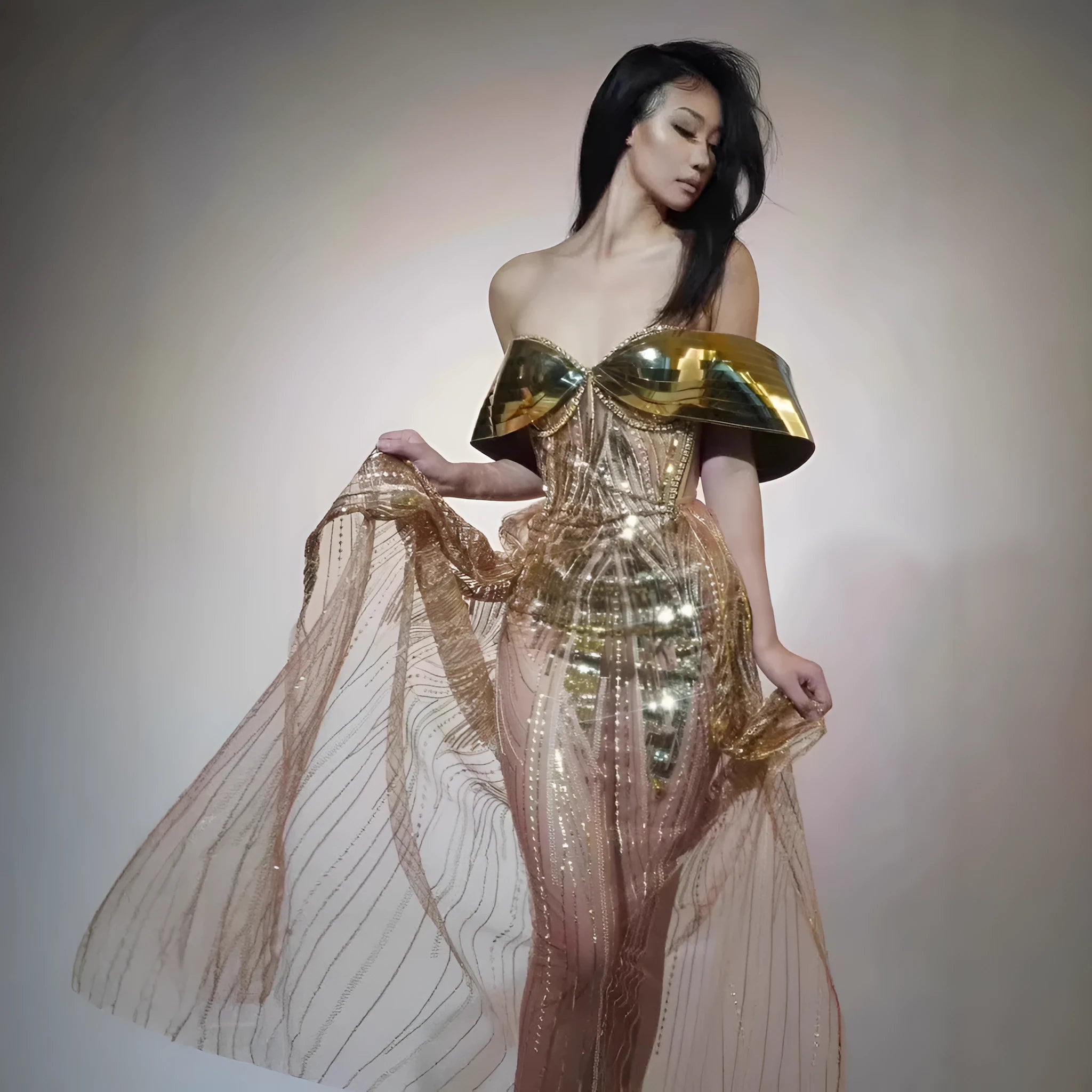 Gold sequined strapless evening dress with a thigh-high split in the long tulle skirt.