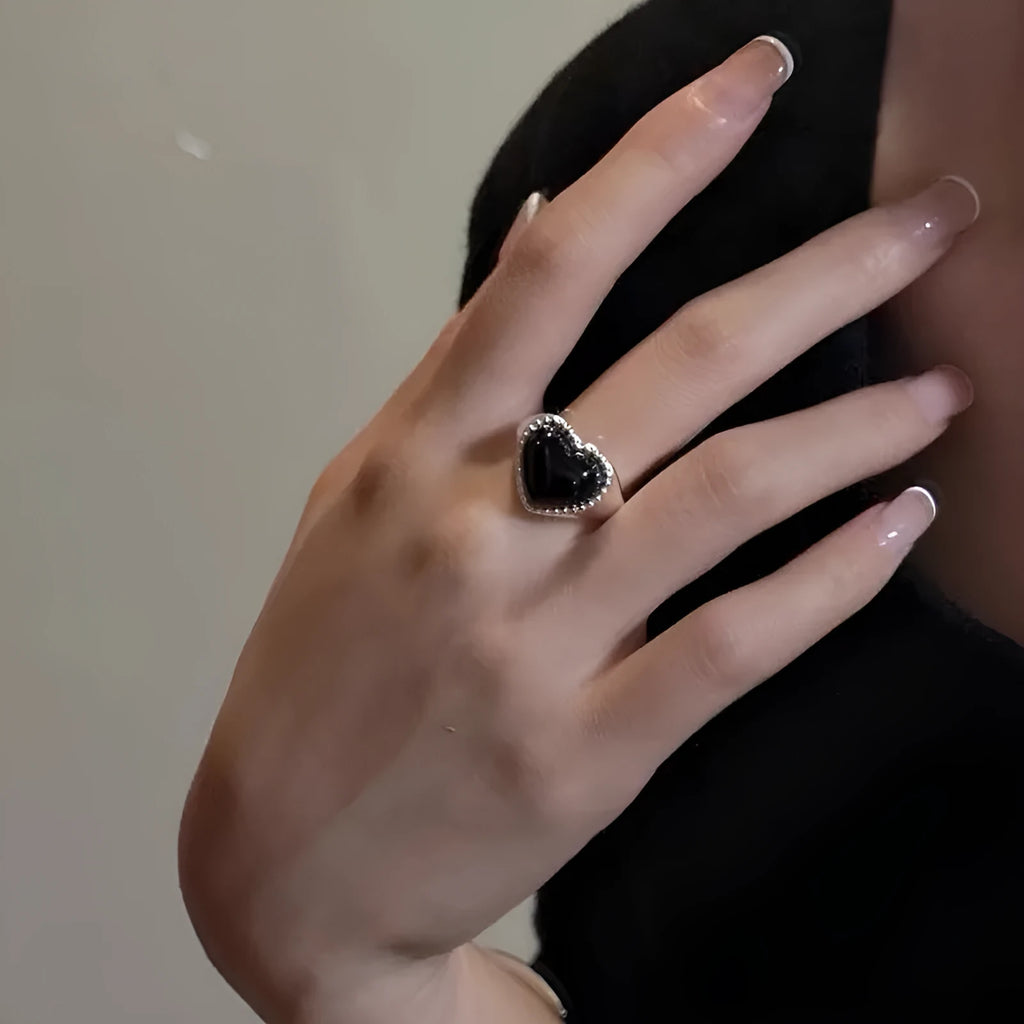 Adjustable open mouth sterling silver ring with a black heart-shaped agate stone.